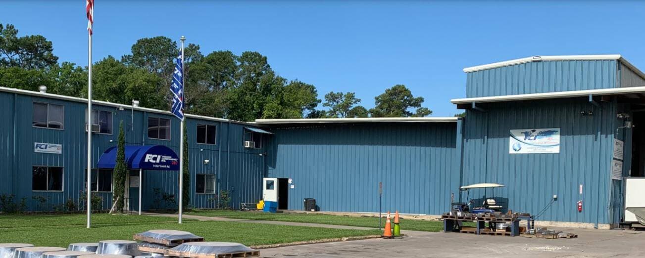 The FCI headquarters office in Humble, Texas, with finished forgings staged on the lawn