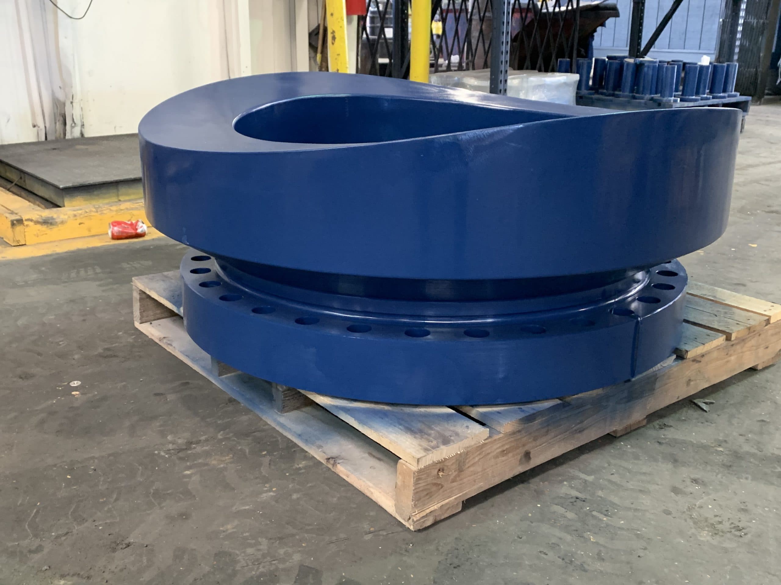 A large blue contoured barrel nozzle on a pallet
