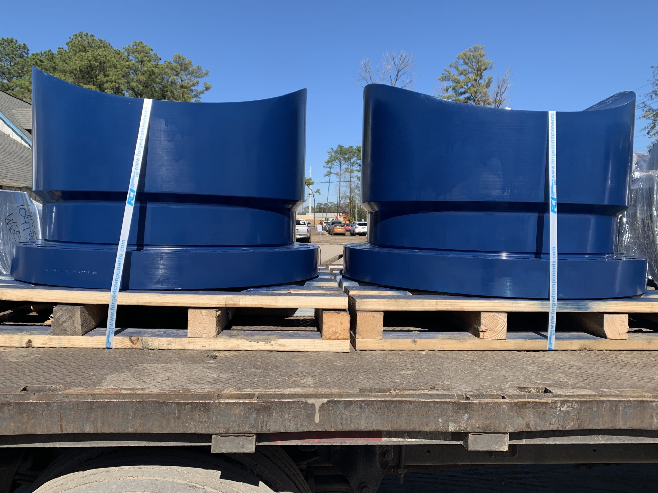 Two contoured nozzles strapped on a flatbed