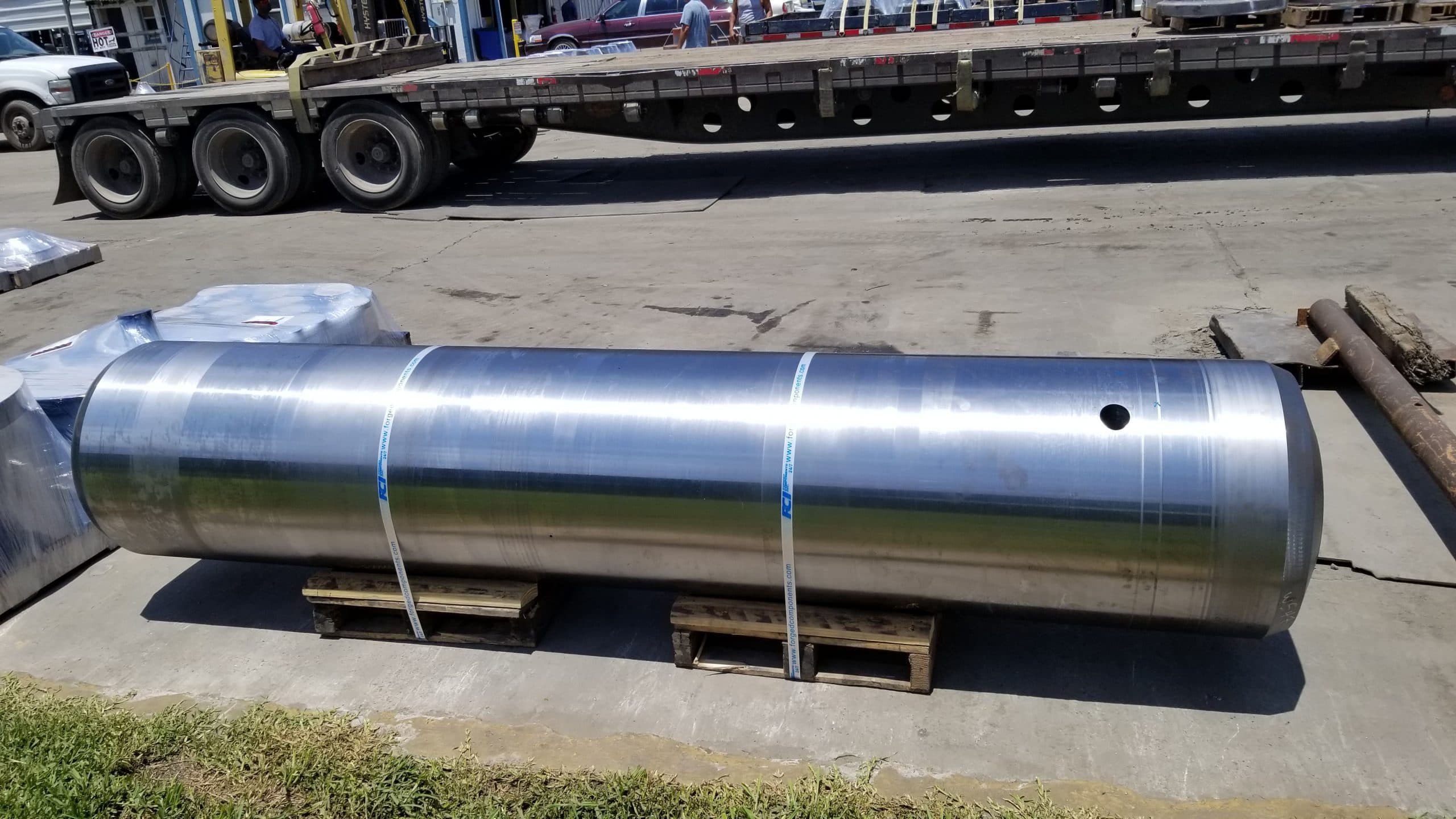 A long machined cylinder on a trailer