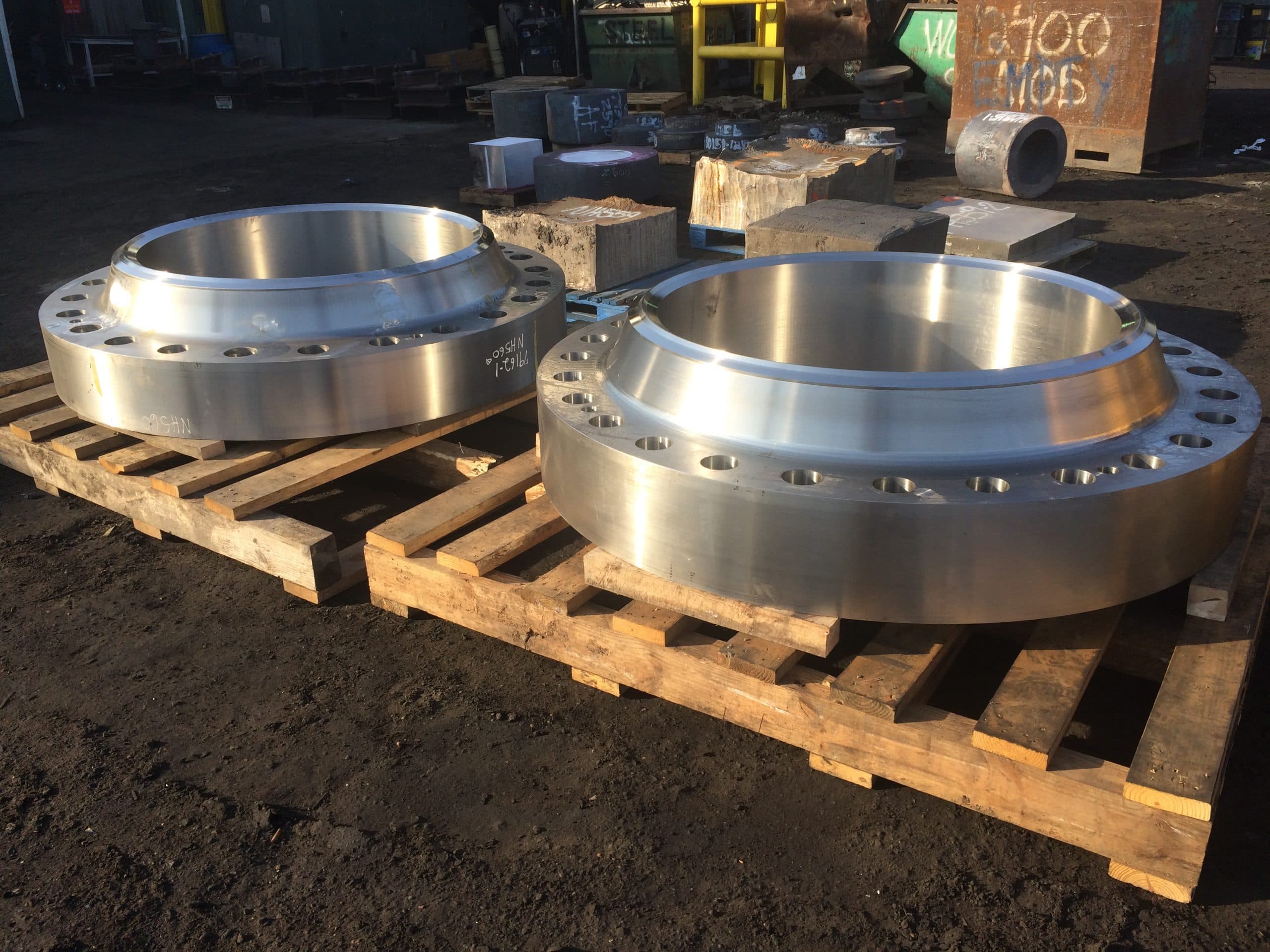 Two large-diameter weld-neck flanges on a pallet