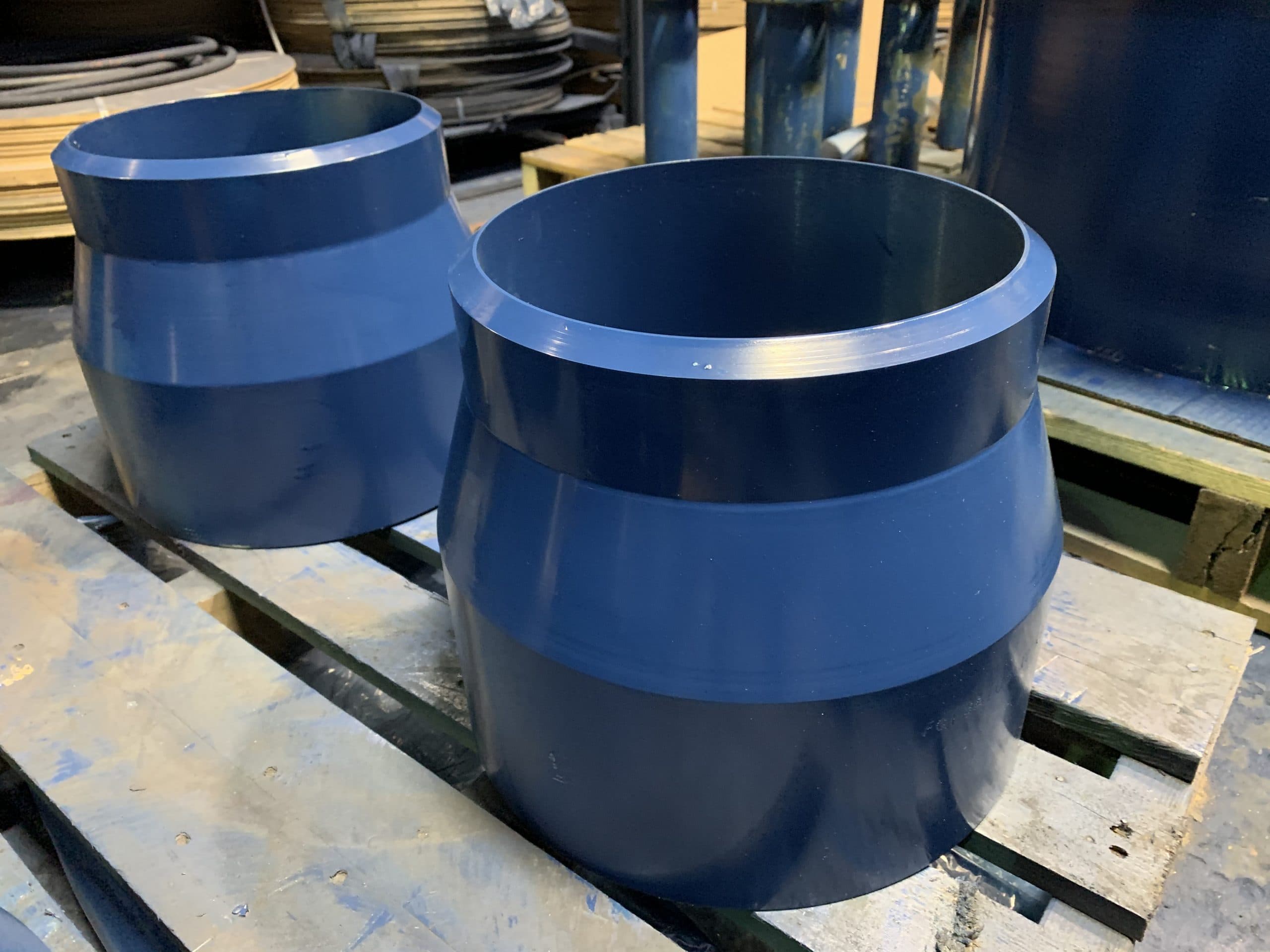 Two large blue stub-end nozzles