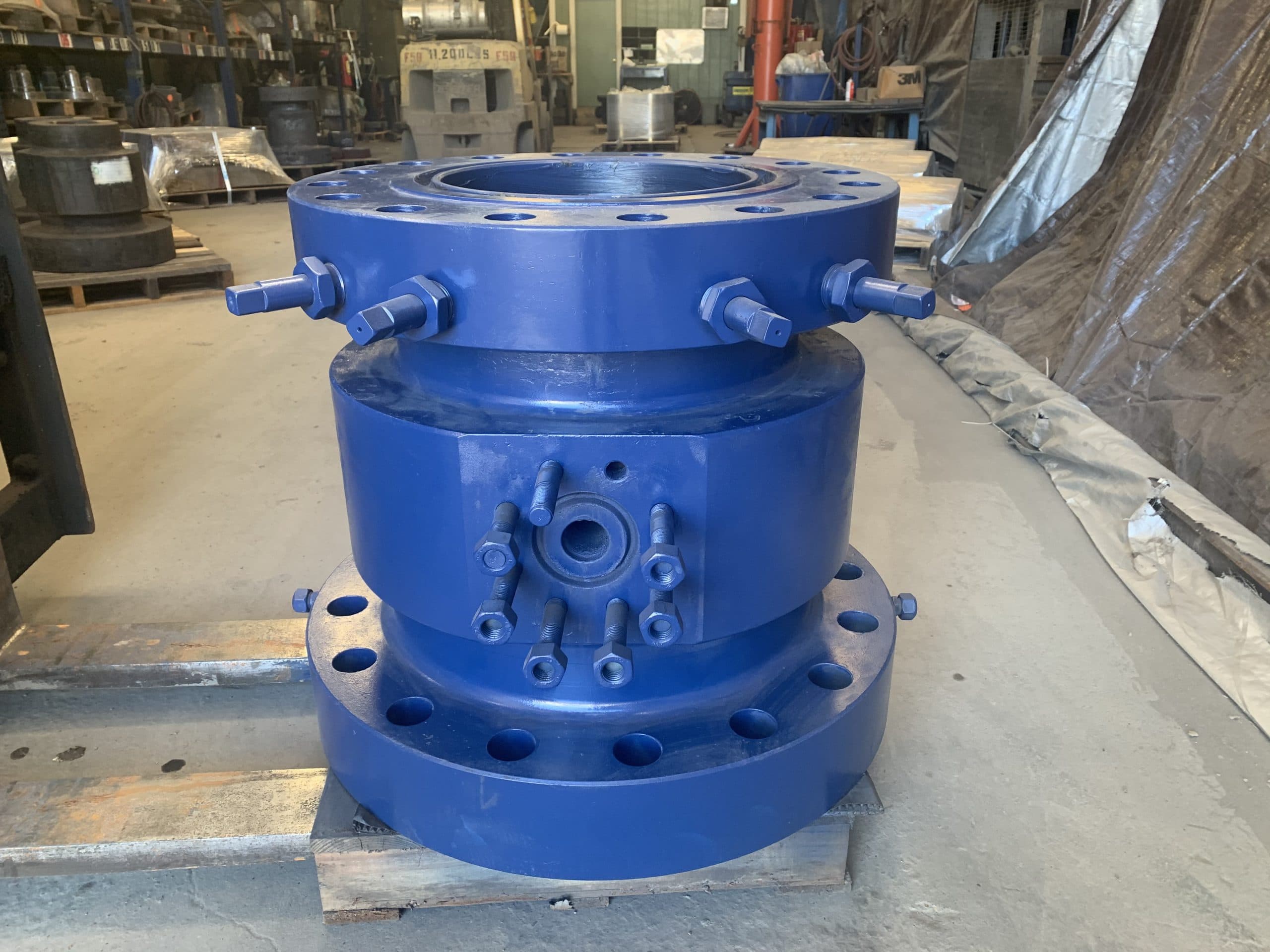 A blue tubing head with ports